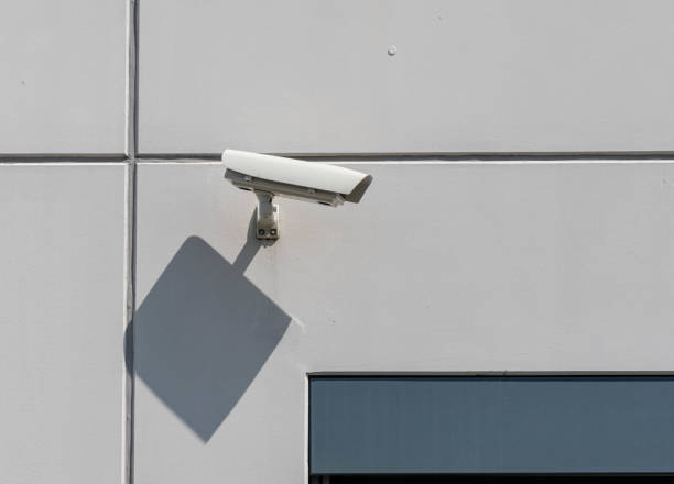 istock Surveillance camera on the gray wall. 1464413567