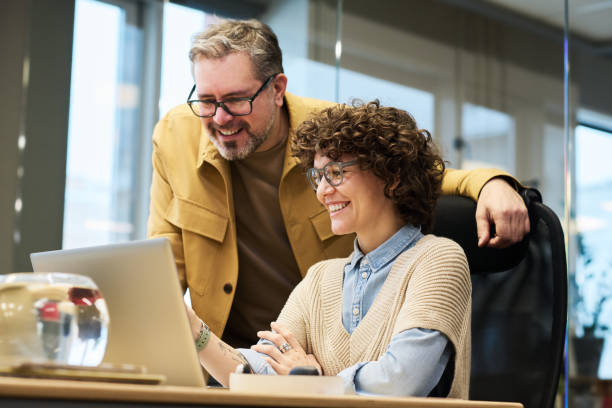 istock Two happy colleagues discussing online data on laptop screen 1464415593