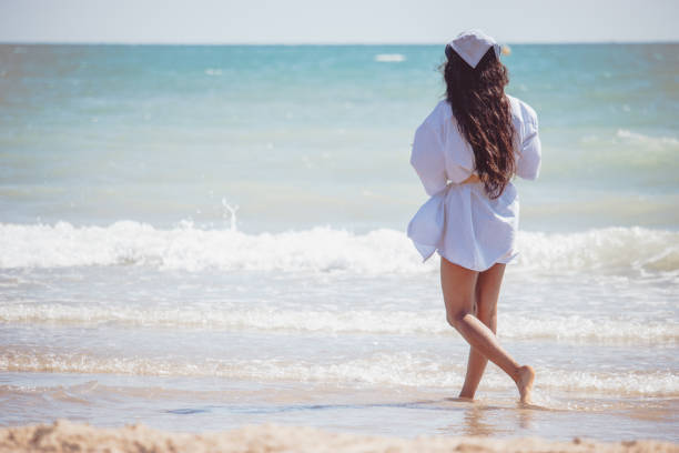 istock Young female running on the sandy beach on a sunny day 1464417533