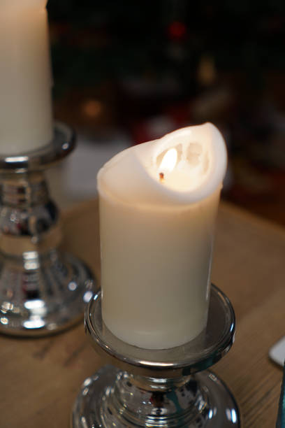 istock Selective of the lit white candle on a silver stand 1464418600