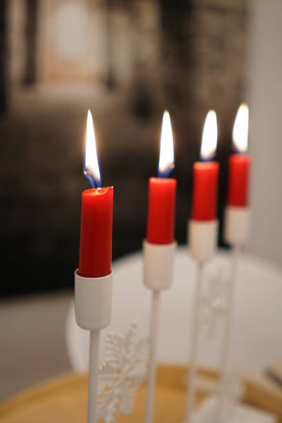 istock Selective of lit red candles on a white candelabra 1464418612