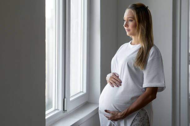 istock Young mother touching her pregnant tummy 1464418925