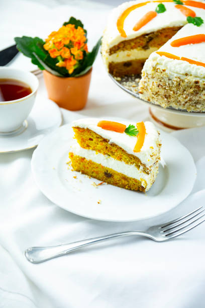istock Closeup of carrot cake on a white plate with a fork 1464419047