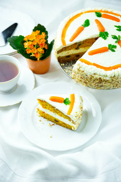 istock Closeup of carrot cake on a white plate with a fork 1464419055
