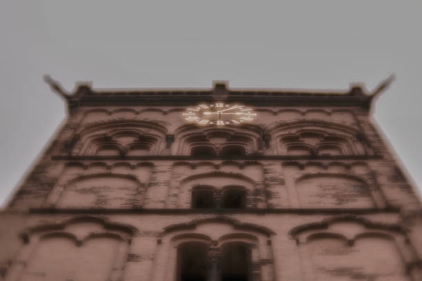 A low angle shot of a building with a clock on the facad