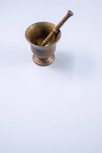 istock Vintage bronze mortar and pestle isolated on a white background with free space for text 1464419876