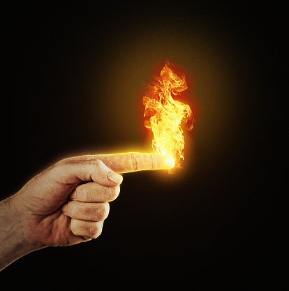 Tip of man's index finger bursts into flames.