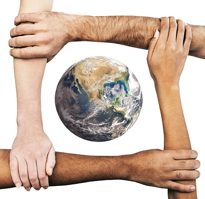 Multiracial group of hands and arms of men and women clasping each other around Planet Earth, signifying care, unity, solidarity, cooperation and teamwork. Public domain satellite Earth image from https://www.nasa.gov/multimedia/imagegallery/image_feature_2159.html