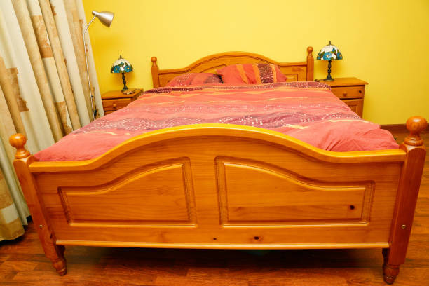 istock Modern comfortable wooden bed with two bedside tables in the bedroom 1464422536