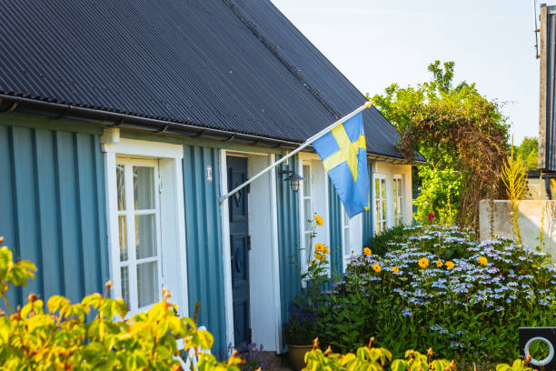 Malmo, Sweden - September 25, 2019: Typical wooden home with Swedish flag in Sweden