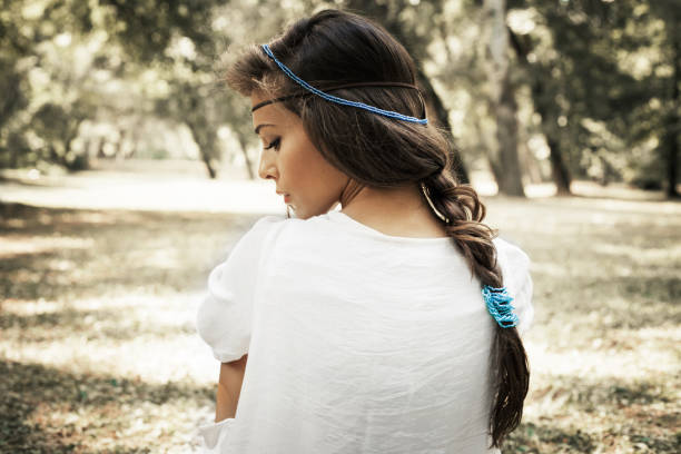 young beautiful woman portrait  in white dress and blue beads in hair, profile, outdoor summer day in forest
