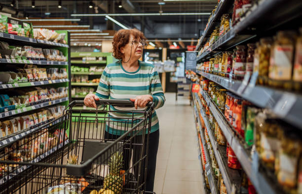 Senior woman in the supermarket stock photo