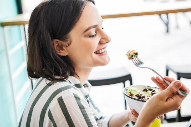 istock Young woman enjoying salad 1464428197