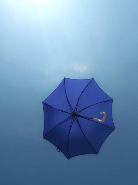 istock Flying umbrella with bluesky background 1464431345