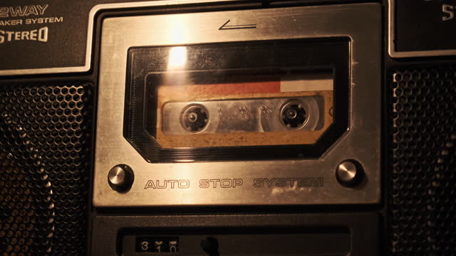 Audio Cassette Playback in Vintage Tape Recorder in Soft Flickering Candlelight