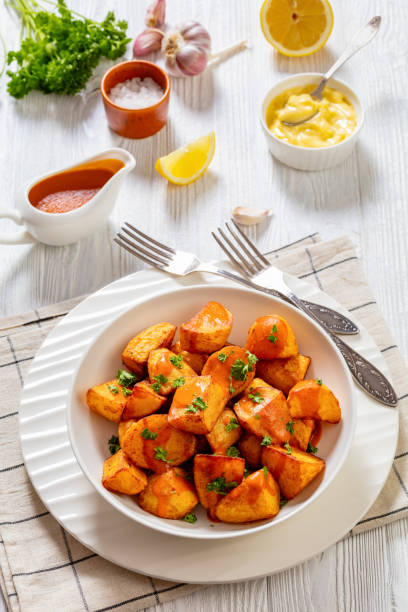 istock patatas bravas, deep fried potatoes with sauce 1464433130