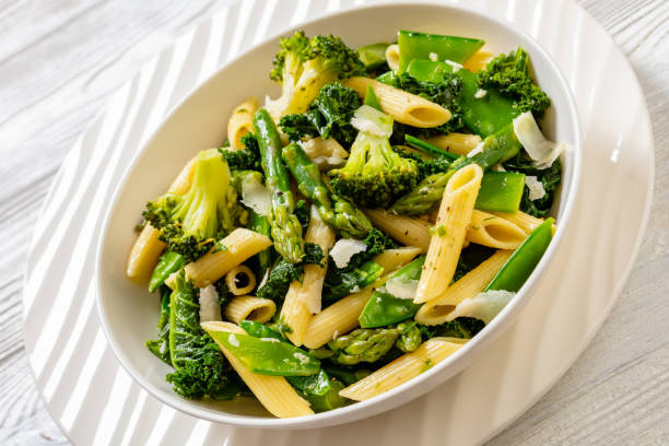 istock Pasta primavera with green veggies, cheese in bowl 1464433615