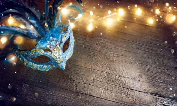 istock Venetian Mask On Wooden Table With Bokeh Lights 1464435150