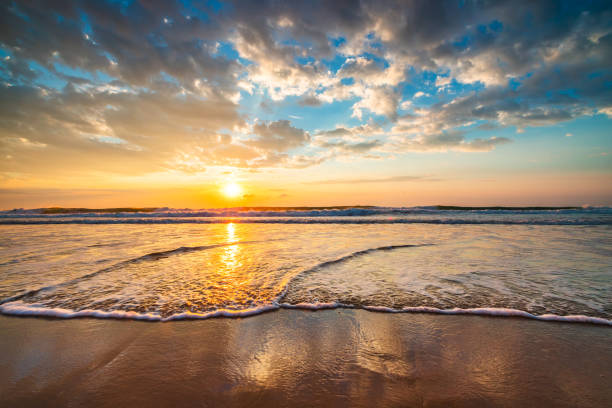 istock Beautiful cloudscape over the sea waves and beach shore 1464435574