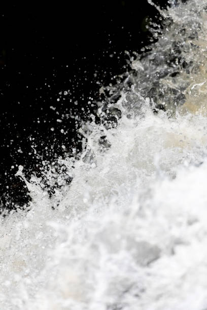 istock Close focus on splashing water of waterfall with dark background. 1464435720