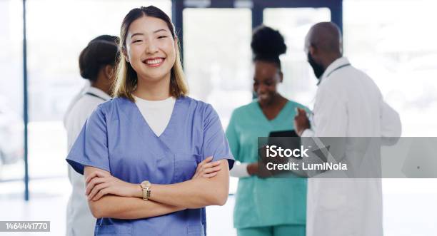 Healthcare Portrait And Nurse With Crossed Arms In The Hospital Standing In The Lobby After Consultation Happy Smile And Professional Asian Female Medical Worker With Leadership In Medicare Clinic Stock Photo - Download Image Now
