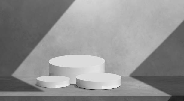 istock Products Display Presentation Background. White Podiums set on concrete wall with light and shadow on surface 1464444271