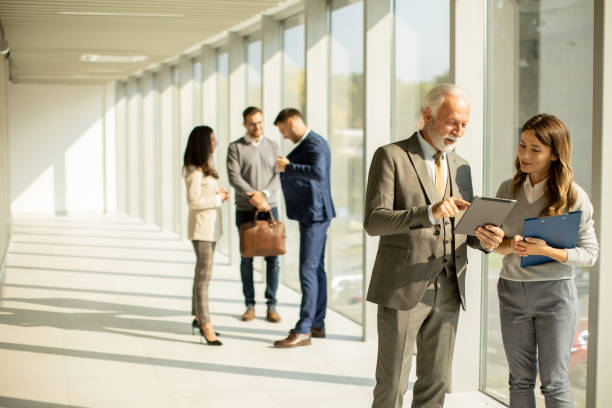 istock Modern business people using digital tablet in the office 1464444293