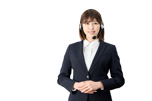 Asian telephone operator standing with headset on