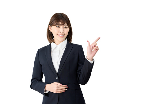 Asian business woman pointing at white background