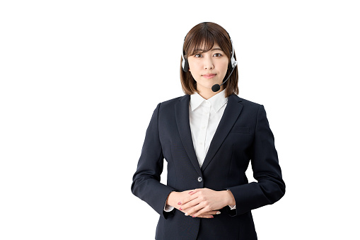 Asian telephone operator standing with headset on