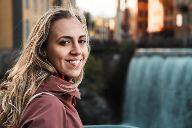 Beautiful girl near a large waterfall.