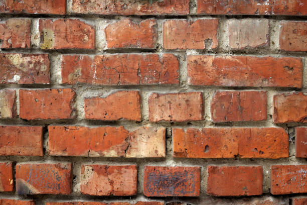 A real old brick wall built of red brick and cement, exterior stock photo