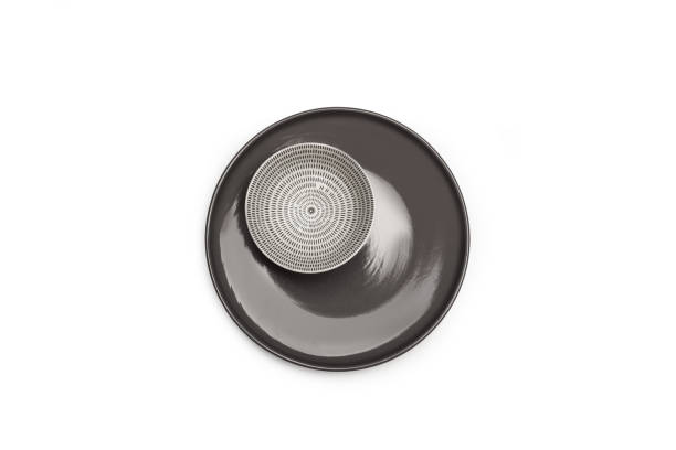 istock A white and black ceramic bowl on a gray plate on a white background with copy space 1464447174