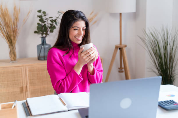 istock Smiling woman with cup of coffee 1464453532
