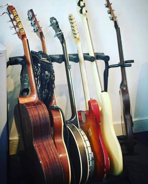 istock Group of guitars in their stand 1464455522