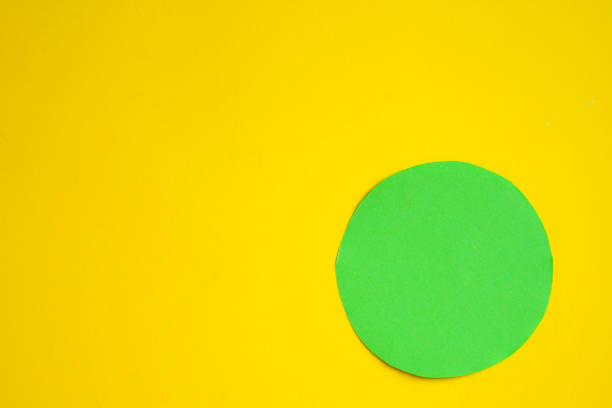 istock Two circles - green and blue on a yellow background. A space to create ideas. 1464456629