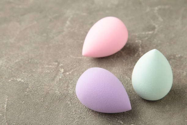 istock Beauty blender on a grey background. Bright sponges for make-up cosmetics. Makeup products. Beauty concept. 1464457971