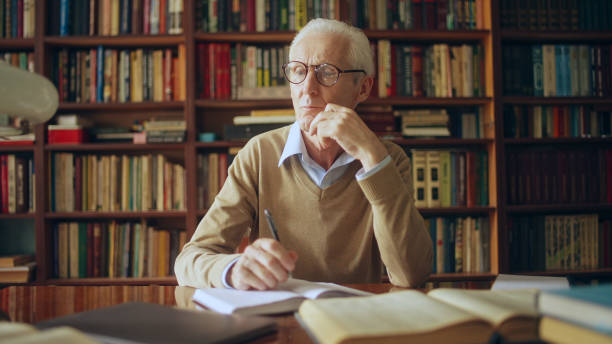 istock Mature journalist writing down notes, preparing article for scientific magazine 1464459326