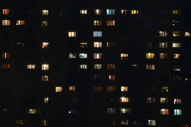 istock Apartment building at night. People staying at home 1464460086