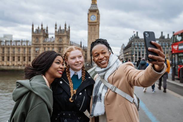 istock Young multi-ethnic tourist in London using smart phone to take selfie 1464460365