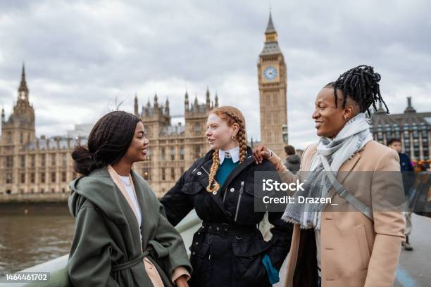 British Youth In Wintertime Outdoors Standing Near Big Ben And Talking Stock Photo - Download Image Now