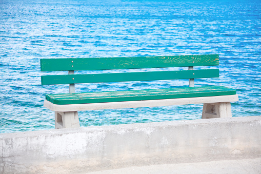 Wooden bench on the seaside . Seat on the sea shore