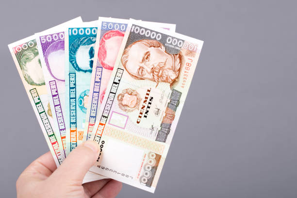 istock Old Peruvian money in the hand on a gray background 1464467463