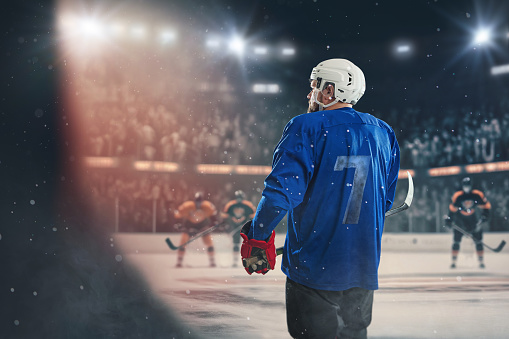 Hockey ice rink sport arena with a hockey player ready to play - stadium