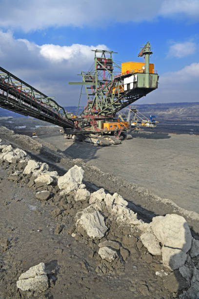 istock Bucket-wheel excavator during excavation at the surface mine. Huge excavator on open pit mine. 1464472375