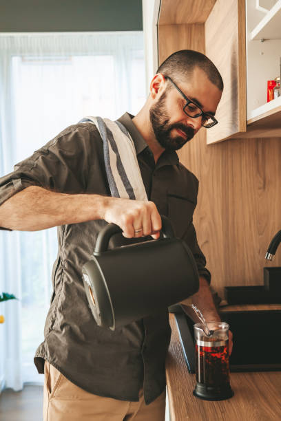istock Man preparing black tea in a teapot 1464474712