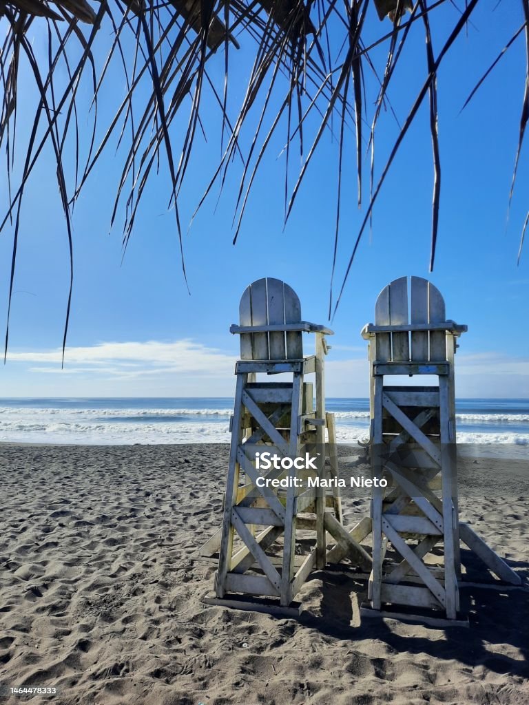 Baywatch chairs In this calm image of the beach we can see two lifeguard chairs Beach Stock Photo