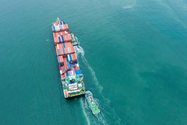 istock Aerial top view of cargo ship carrying container for import export goods send to customer from cargo yard port and running with tug boat  ,concept logistic and supply chain 1464479041
