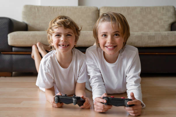 istock Cute children joyful playing video games with controller console, brother sister expressing emotions while enjoying their hobby playstation joystick. 1464479193