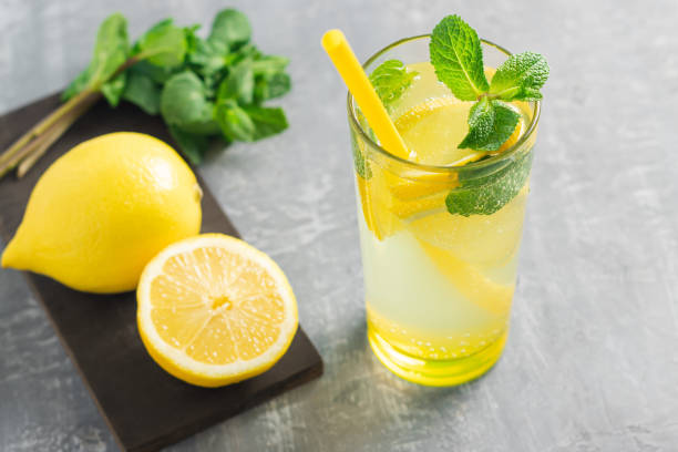 istock Lemonade drink or mojito cocktail in a glass with straw, lemon fruit and mint leaves, refreshing summer beverage 1464482015